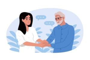 Une jeune femme et un homme plus âgé, qui se tiennent la main et discutent.